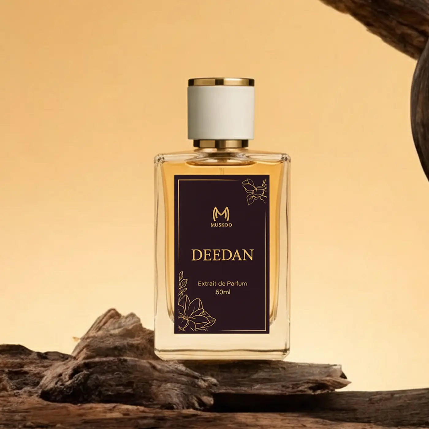 Deedan Muskoo 50ml Extrait de Parfum bottle with gold and black label on wood background